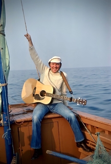 Liam Clancy in a boat